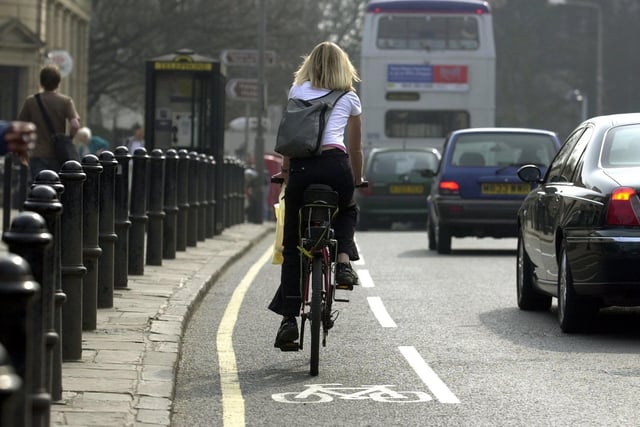 A cyclist makes her way through Headingley along the cycle lane.  