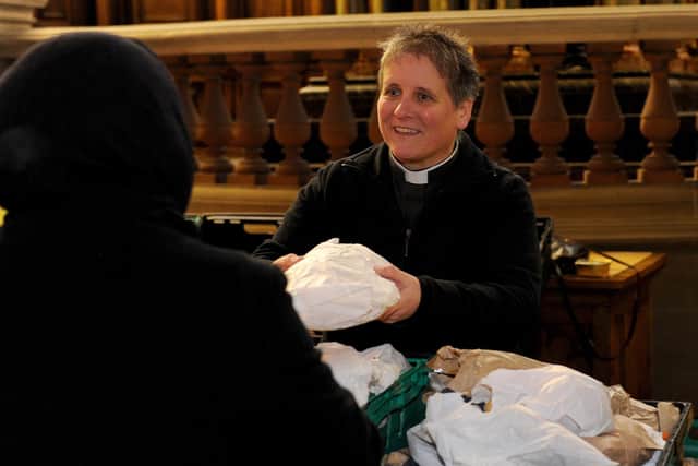 Mother Andi Hofbauer, Vicar of St Aidan's Church, is pictured giving food to an attendee. Picture: Steve Riding