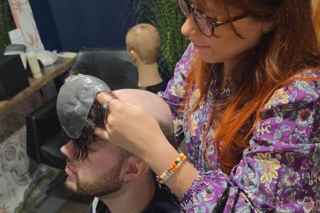 Hairdresser Martina Stanton attaches the new hair system to client Josh Britton at Joseph Ferraro Hair, Harrogate.