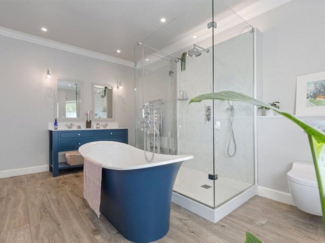 The master bedroom en suite has underfloor heating a walk in shower and roll top bath.