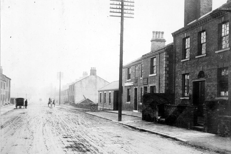 The Brown Cow Inn on Stanningley Road. There are several horse and cart/horse and carriages on the road, and telegraph poles down the right hand side of it. This photo is undated but possibly early 1900s.