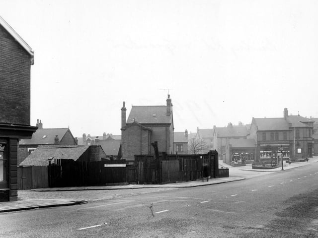 Looking at the south west side of Burley Road in January 1955. To the left of the picture is 'A. Woodhouse & Sons, painters'. To the right of the picture, at the junction of Haddon Road, is the 'Leeds Industrial Co-operative Society Ltd'.