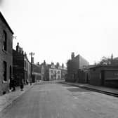A view looking South along Oak Road in September 1945. 'Brunswick Hotel', 'Geo Stokehill House Furnishers' and shop of 'Elizabeth Nutter' visible. People in street. End of Stapletons Row can be seen.