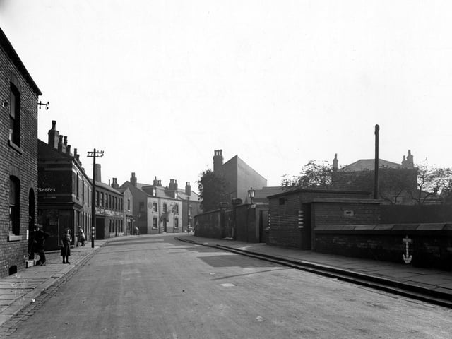 A view looking South along Oak Road in September 1945. 'Brunswick Hotel', 'Geo Stokehill House Furnishers' and shop of 'Elizabeth Nutter' visible. People in street. End of Stapletons Row can be seen.
