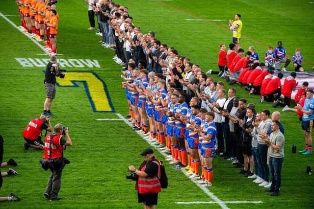 Rob Burrow's former teammates line up on the pitch at AMT Headingley behind the current team before kick-off against Leigh Leopards. Picture by Bruce Rollinson.