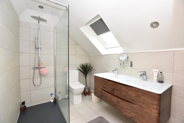 The bathroom has a three-piece suite in white which incorporates electric shower facilities over the bath, ceramic tiled walls, cast iron radiator and window to the side.