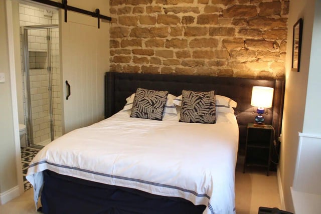 Upstairs, one of the bedrooms features an exposed wall and can be converted to two single beds.