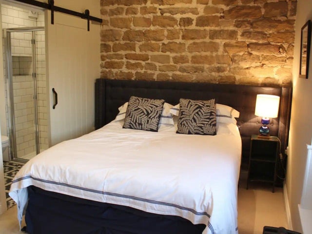 Upstairs, one of the bedrooms features an exposed wall and can be converted to two single beds.