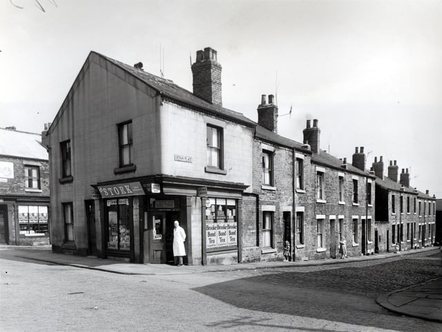 Camp Road and Sedan Place in July 1958. On the left is Woerth Street with a shop at number 92 Camp Road top the left edge. At the time this was owned by James Abbot and had previously been owned by Emily Richardson. Next number 90a Camp Road (Oatland Lane). A man in a white overall is in the doorway of 90, which is a grocers shop, business of S.C. Stocks. Sedan Place is next, number 3 has a girl in the doorway.