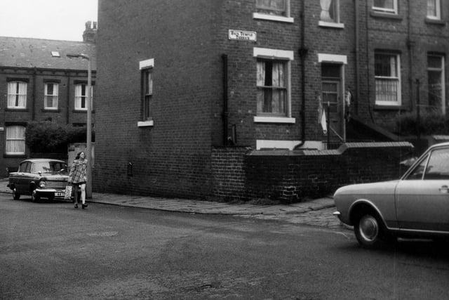 June 1973 and a woman walks along Normanton Street with Leyburn Terrace visible behind. On the right is Back Temple Terrace, here are the rear entrances and yards to through terraced houses numbers 2 and 4 Leyburn Terrace.