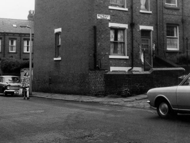 June 1973 and a woman walks along Normanton Street with Leyburn Terrace visible behind. On the right is Back Temple Terrace, here are the rear entrances and yards to through terraced houses numbers 2 and 4 Leyburn Terrace.