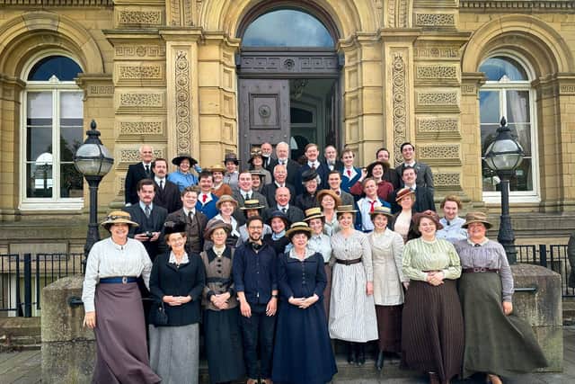 Members of the choir in The Choral outside Victoria Hall in Saltaire, including Anne Henshaw, third left on the bottom row next to choral music director Joseph Judge.