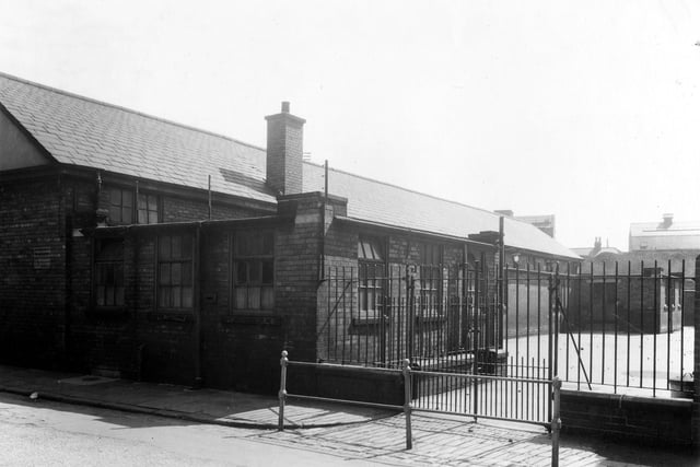 Christ Church Infant School, located between Scarsdale Street (not in view here on the left) and Church Cross Street. The school playground can be seen in this view from July 1959.