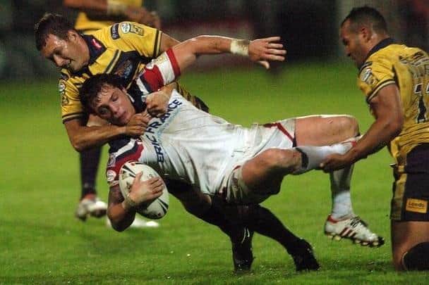 Leeds Rhinos' Danny McGuire and Jamie Jones-Buchanan tackle Wakefield Trinity's Scott Grix in September, 2008. Grix is now a Leeds assistant-coach.