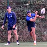 David Fusitu'a passes in training, watched by Leeds Rhinos teammate Harry Newman. Picture by Simon Hulme.