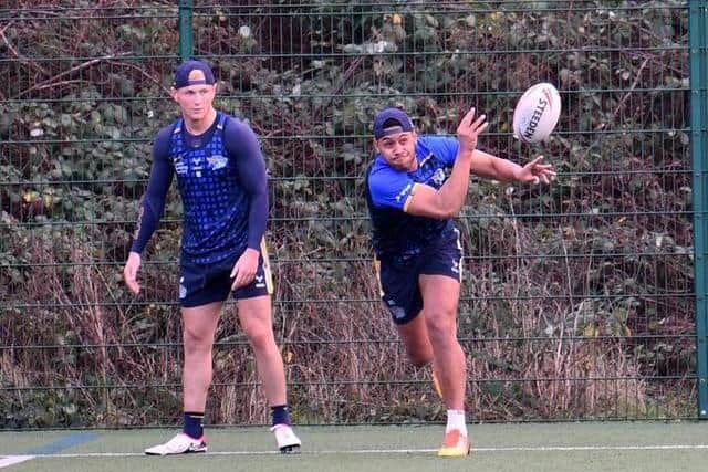 David Fusitu'a passes in training, watched by Leeds Rhinos teammate Harry Newman. Picture by Simon Hulme.