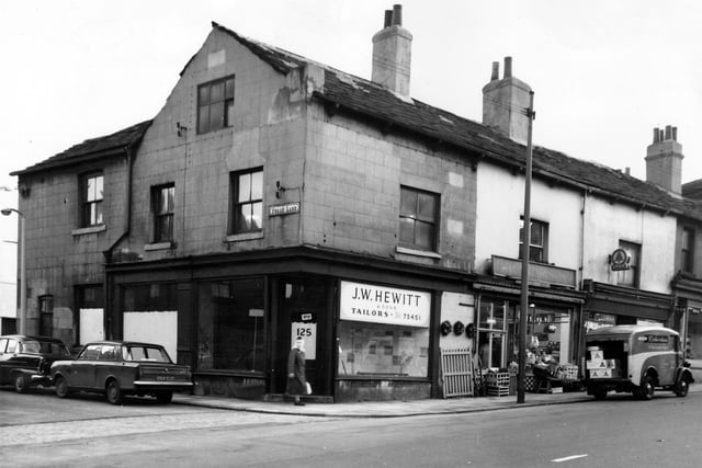 Beeston in December 1965. To the left is Folly Lane, at the corner is 125 Beeston Road. J.W.Hewitt and Sons, tailors. Moving right 127 is a greengrocers, business of R K Richardson. The delivery van belongs to the shop, on the wall above the gate are Christmas wreaths. Next, number 129 is a Spar grocers.