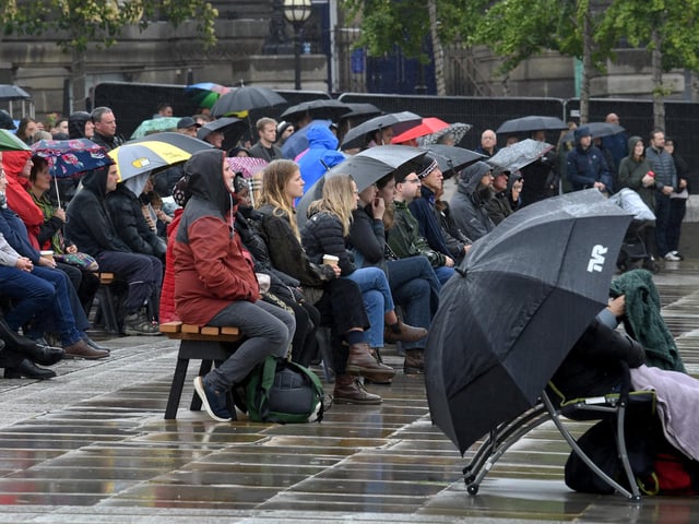 Mourners braved the rain as they watched events at Westminster Abbey unfold on the big screen