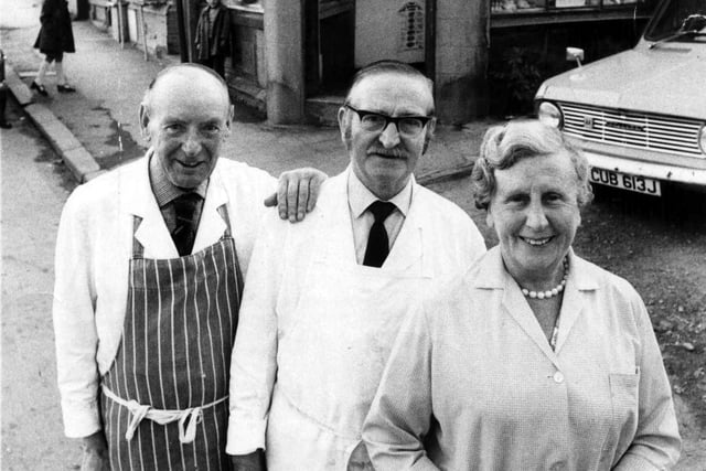 Kitty Lister and her staff are pictured on the day of her retirement from the family butcher's business in Bramley in Juky 1975. Lister's English Meat Purveyors on Lower Town Street, can seen in the background. The shop had originally been run by her parents, Harry and Emma (nee Shaw) Lister. It was located on the corner with Farrar's Yard. Her Uncle Walter also ran a butcher's shop, for 52 years, at number 266 Upper Town Street, on the corner with Bell Lane. Kitty Lister's shop was subject to a compulsory purchase order in 1975 to make way for new development in that part of Town Street. She was eventually relocated to a flat in Snowden Fold, located across the road. Kitty was a well-known character in Bramley and an active supporter of Bramley Rugby Union League Football Club. She died in the May of 2002.