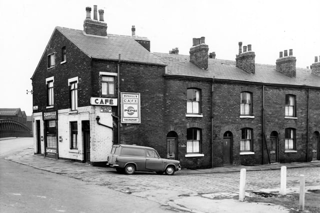 Dunhill's Transport Cafe on South Accommodation Road pictured in May 1967. In view is the suspension bridge over the River Aire. Hunslet was located on the other side of the bridge. John Eaton Street is to the right.