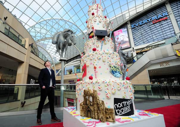 Dan Wharton with a three  cake to celebrate 5 years of Trinity Leeds being open. Picture by Simon Hulme