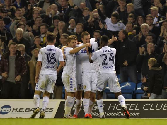 Leeds United players in front of the Elland Road crowd.
