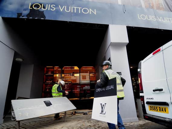 Work began this morning to clear up the damage from the latest raid on Louis Vuitton in Leeds. Picture: Ross Parry