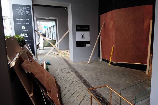 The Louis Vuitton store in Briggate is boarded up following the ram-raid. Picture: Ross Parry