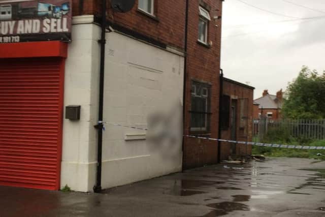 The racist graffiti, blurred out, on the wall of the building in Dewsbury Road, Beeston.