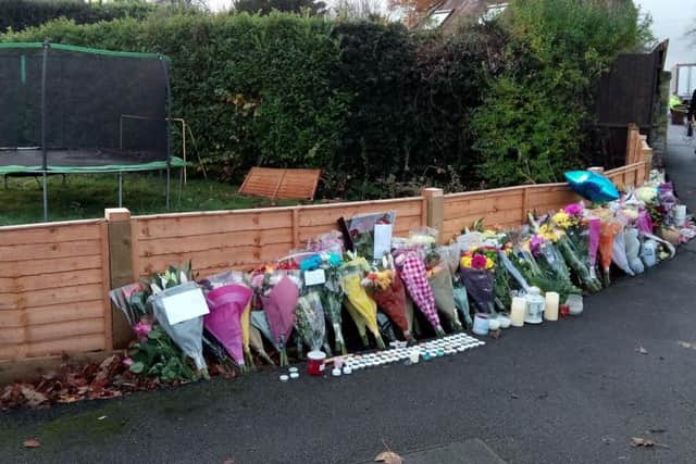 The amount of floral tributes add up as friends come to pay respects to the five killed in the crash.