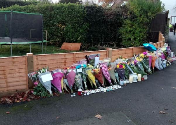 The amount of floral tributes add up as friends come to pay respects to the five killed in the crash.