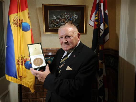 Alan Roberts with his medal.