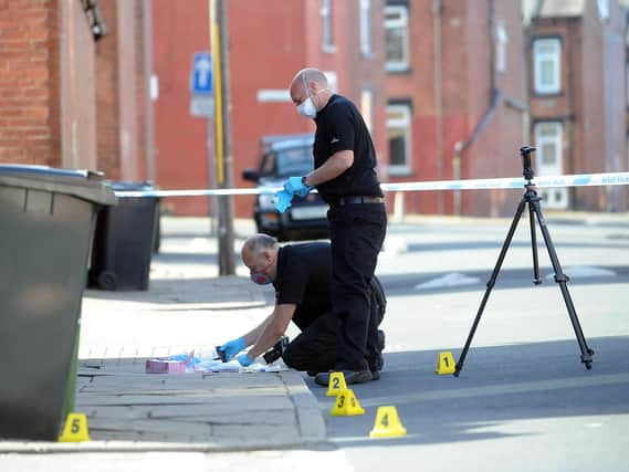 Forensic officers work at the scene. PIC: Simon Hulme