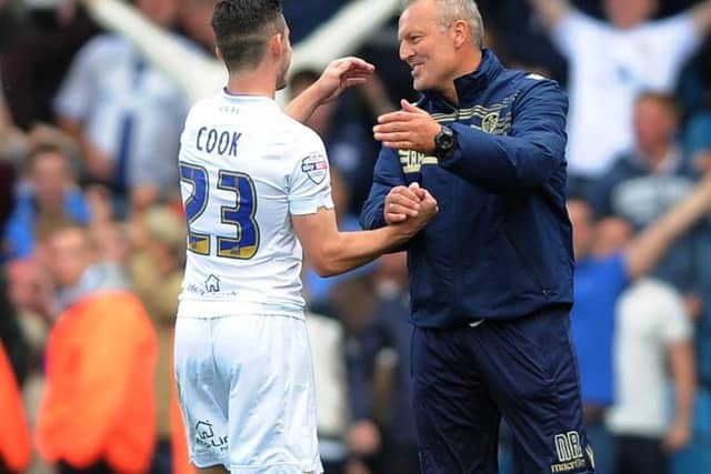 Neil Redfearn embraces former Leeds United midfielder Lewis Cook.