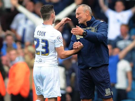 Neil Redfearn embraces former Leeds United midfielder Lewis Cook.