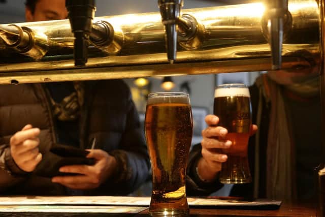 Customers collecting their drinks at a bar. Picture by PA Archive/PA Images