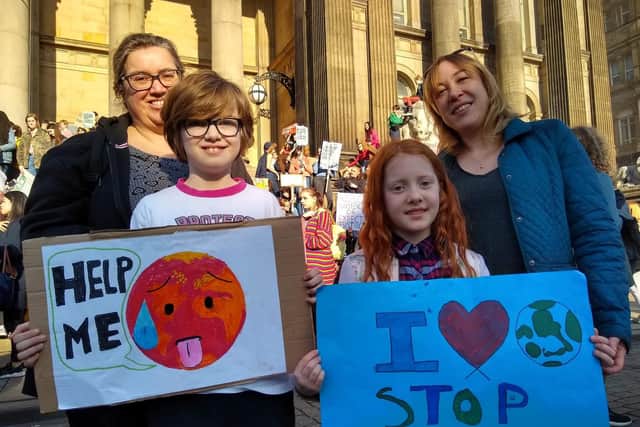 Erica Thompson and Erin Tan with their mums at the Youth Strike 4 Climate protest at Leeds Town Hall.