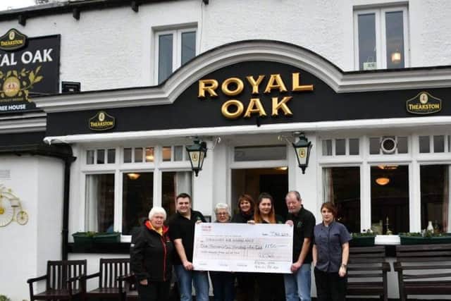 Staff at the Royal Oak in Nidderdale present the funds to Lin Stead, North Regional Fundraiser for the Yorkshire Air Ambulance