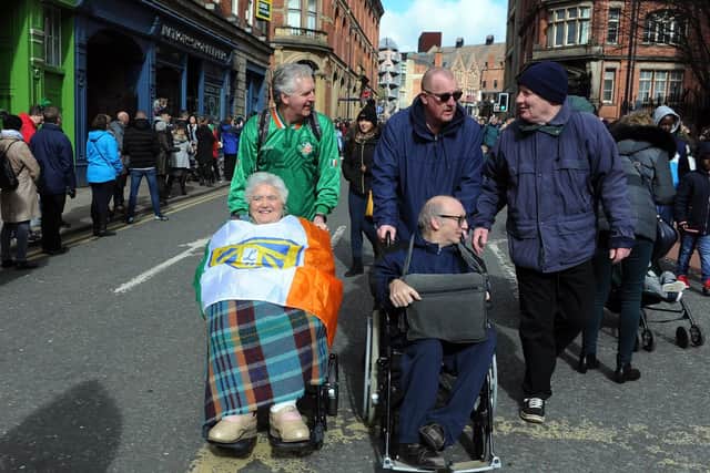 Young and old bedecked in the Irish flag arrive for the parade