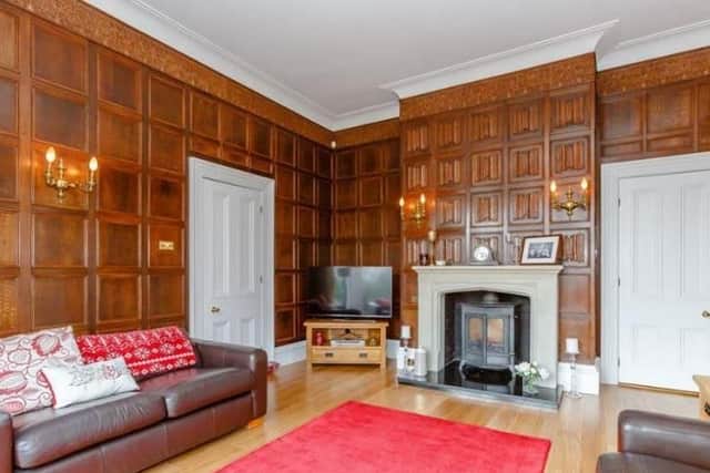 This room boasts oak panelling and stone fireplace with wood burning stove.