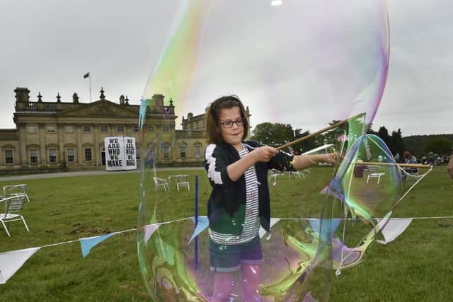 Charlotte Crowe, seven, from York, has fun making giant bubbles at Harewood.