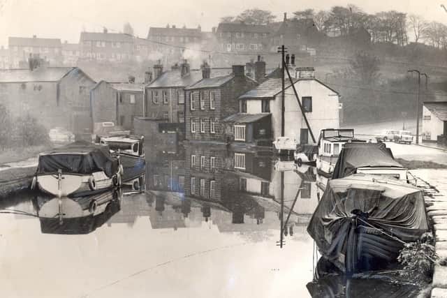 Reflections of hoses in the still waters of the Leeds and Liverpool Canal at Rodley.