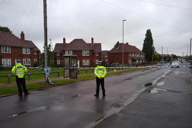 Police officers guard the cordon in Cardinal Road.