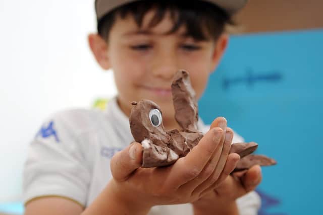 Alfie Brown, 8, with a shark he made at Firefly Pottery.