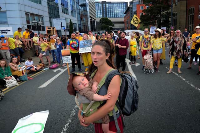 A protester carrying her child on Victoria Bridge.