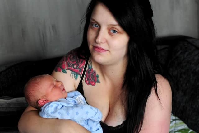 Dana Harrison and her partner Aiden Ibbotson with their baby Blake, pictured at their home at Seacroft, Leeds. Picture by Simon Hulme