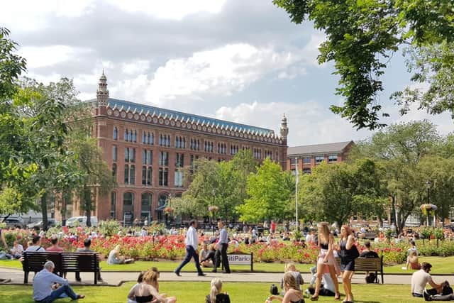 Sunbathers enjoying the heatwave on Park Square.