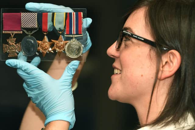 Exhibitions curator Ruth Martin with Flight Sergeant Arthur Aaron's war medals. Picture: Jonathan Gawthorpe