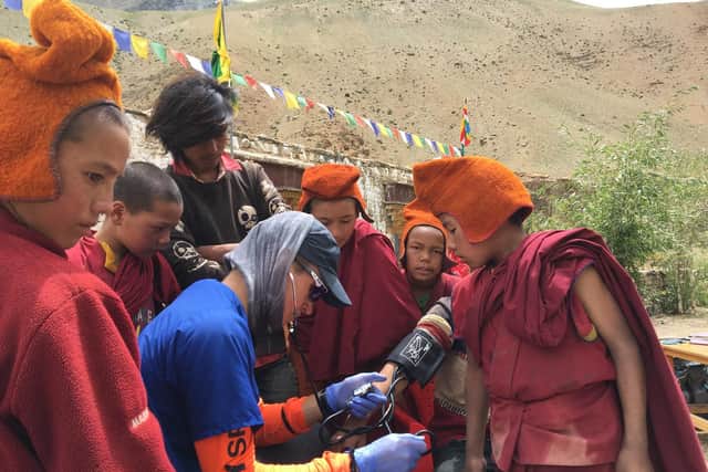 Christopher Pickles, medical student from the University of Leeds, checking the blood pressure of a young Buddhist monk in Ladakh, Kashmir, Himalayas, north India. Photograph credit: Christopher Pickles.