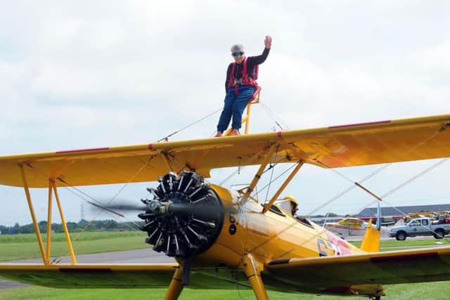 Jean Piper, 71, gives a wave as the aeroplane takes off from Breighton Airfield in Selby. Picture: Simon Hulme
